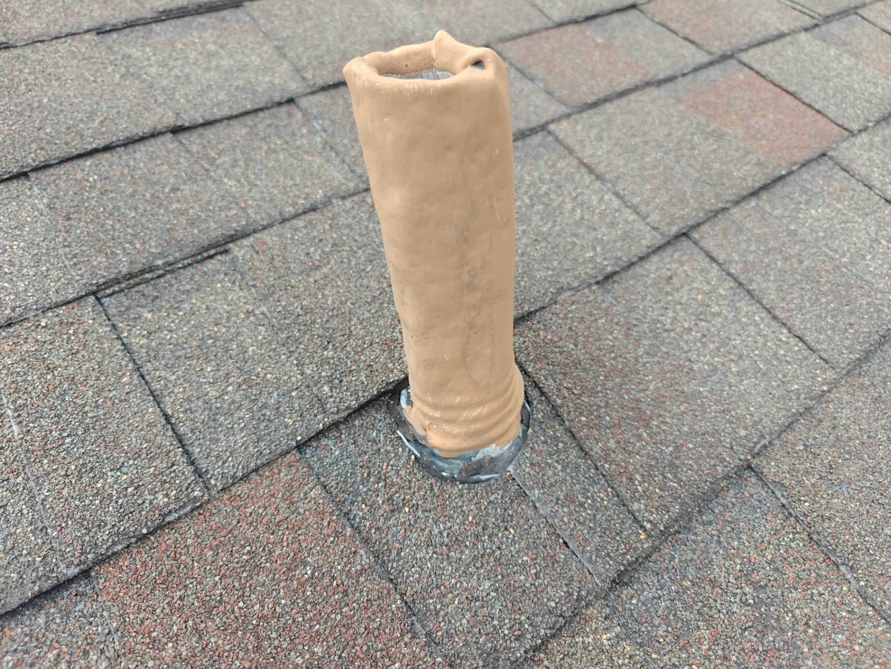 Deteriorated pipe boot flashing sealed with mastic