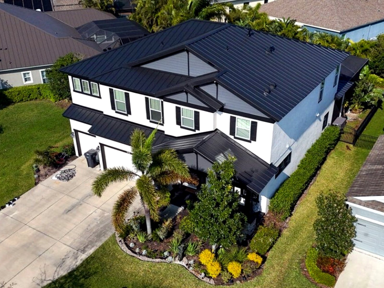 Aerial of a completed black standing-seam metal roof on a large estate home