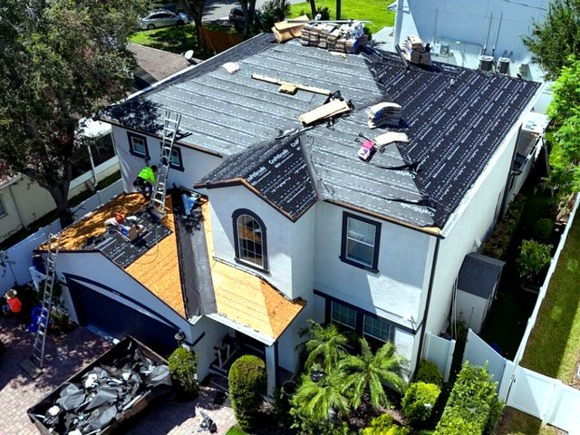 New plywood decking and synthetic underlayment during the reroof