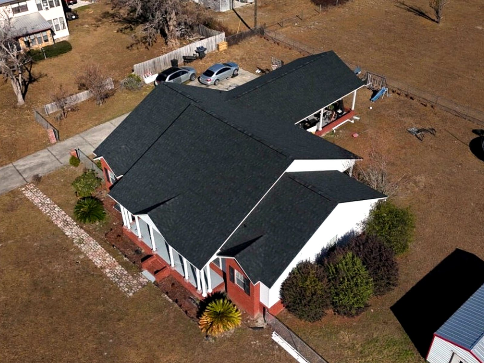 Deep black shingle roof on a restored country farmhouse