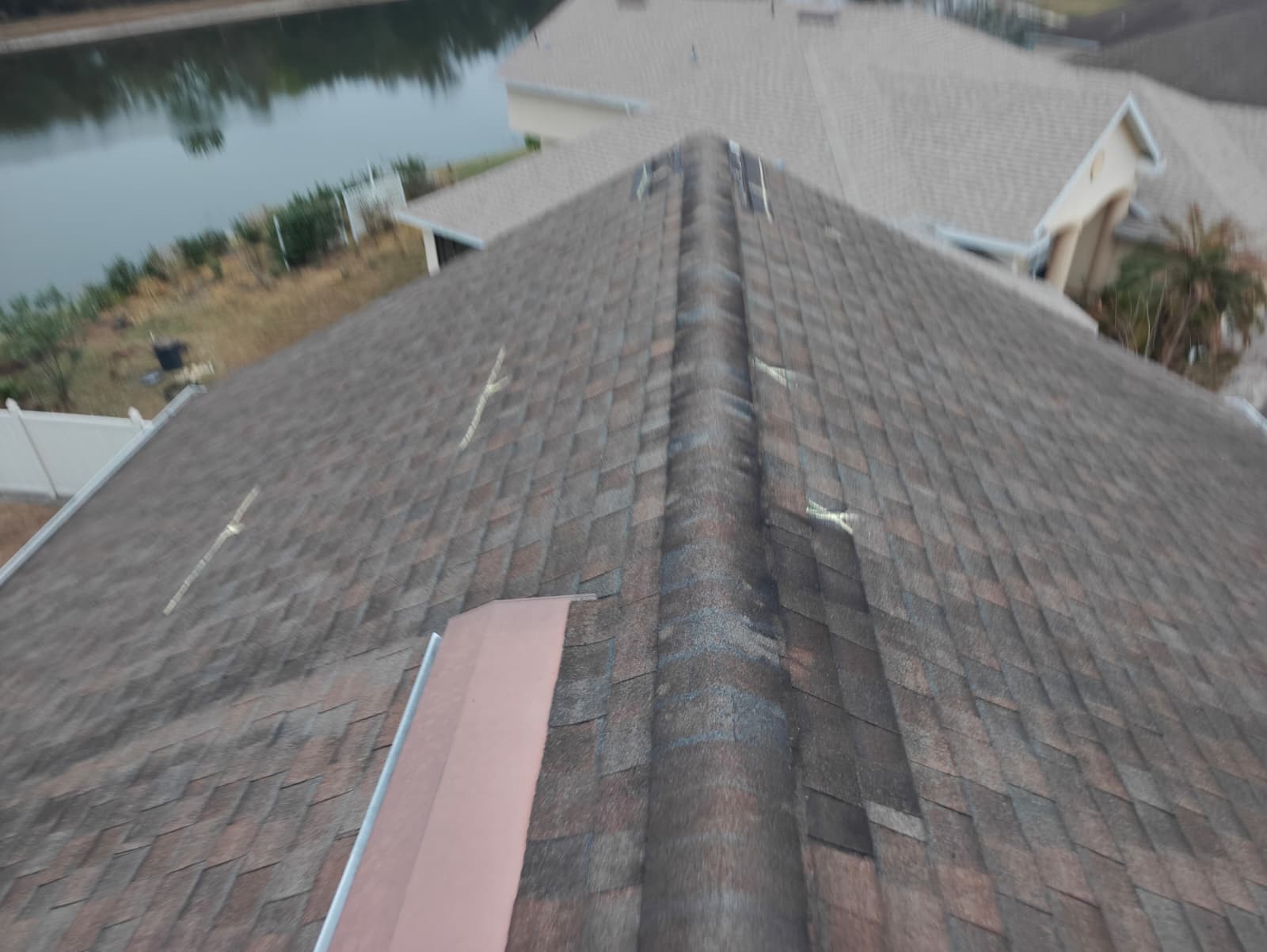 Worn and weathered hip shingles on an aging Florida roof